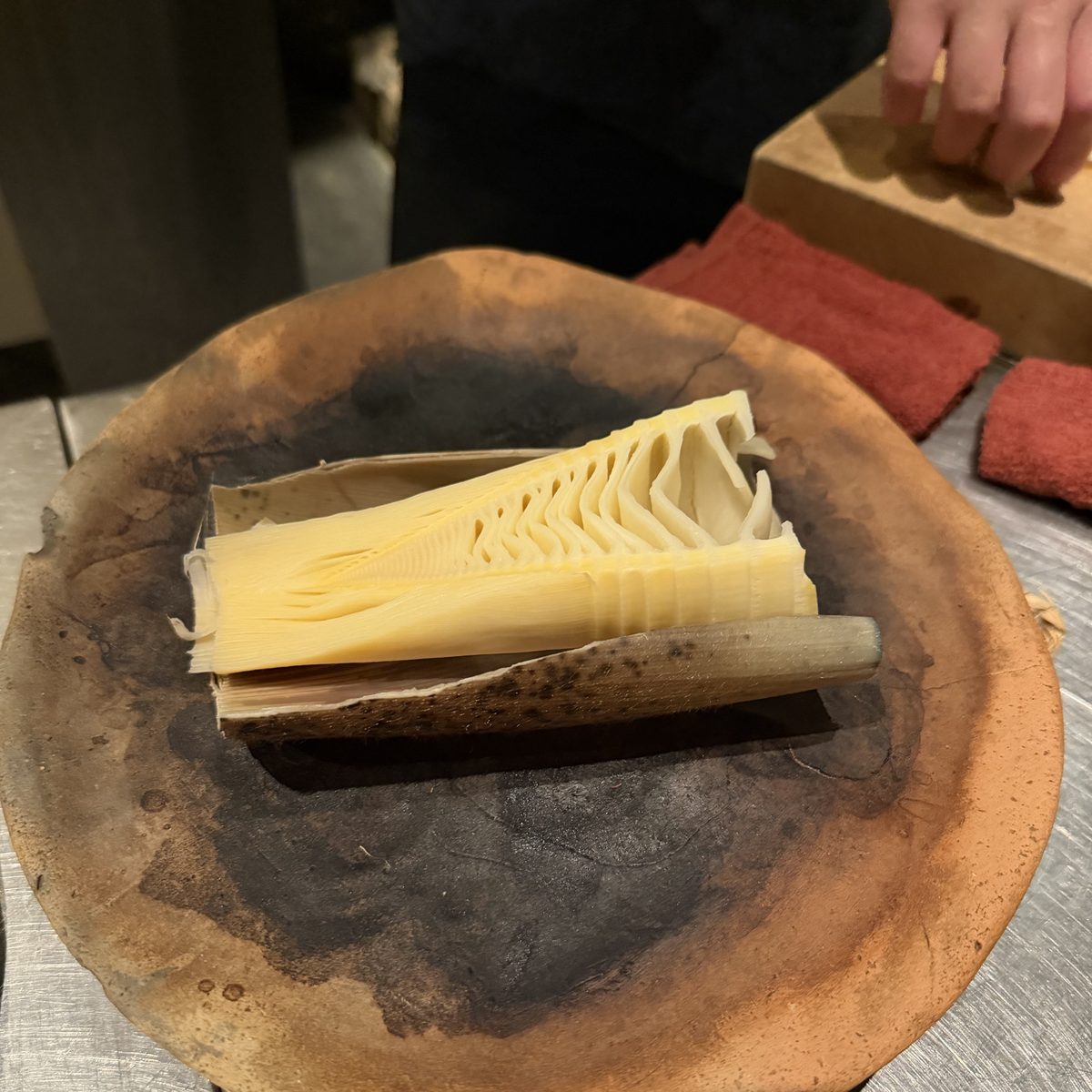 Sliced bamboo shoot, served on an earthenware plate.