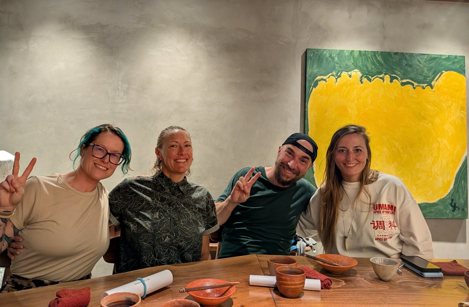 Four friends at the counter after dinner, smiling.