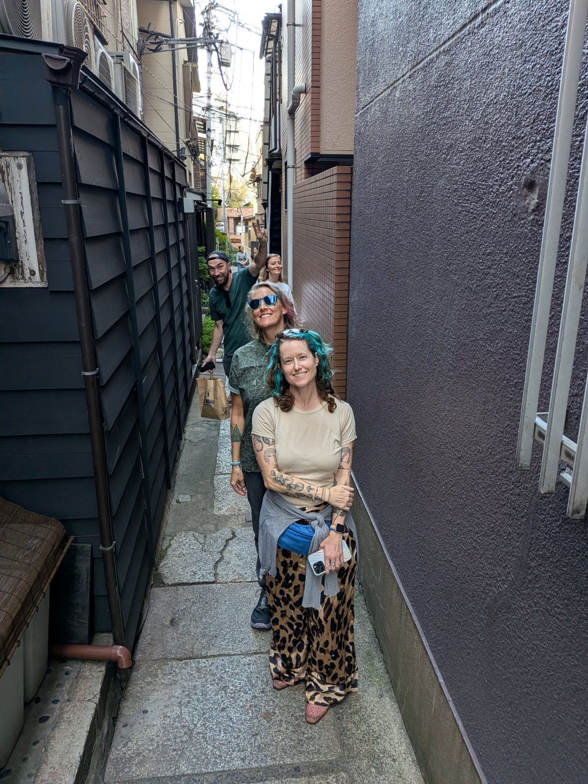 Four friends walking a narrow Kagurazaka back alley.