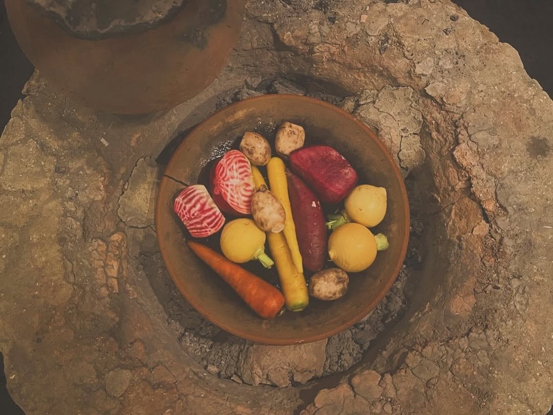 Beets, carrots and turnips in a clay dish over the hearth.