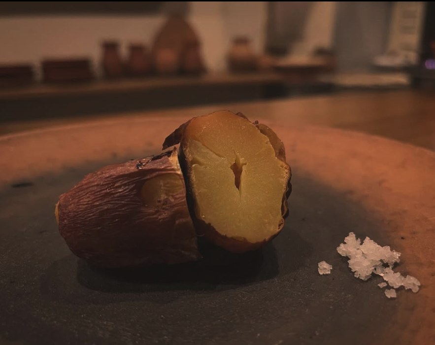 A roasted sweet potato, split open, with salt.